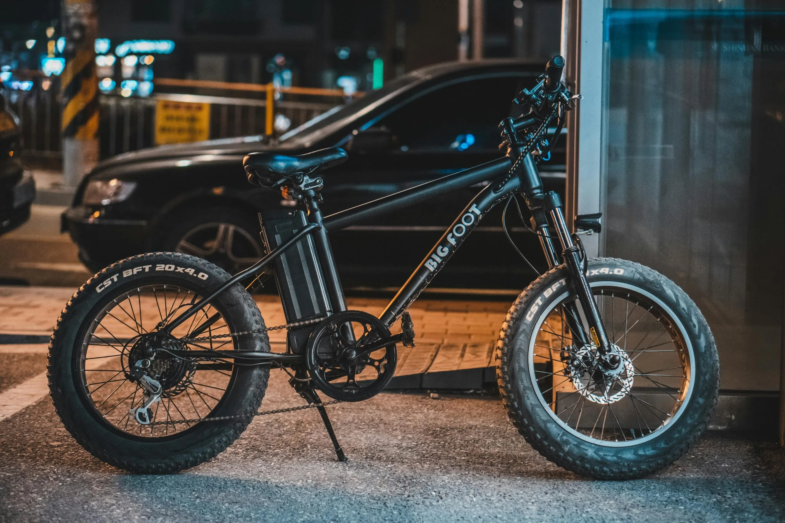 Close-up of an orange electric bicycle on a city street