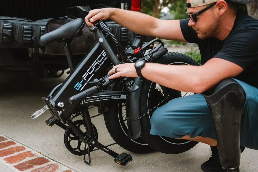 Man folding a compact electric bike next to a vehicle showing portability — folding e-bike guide
