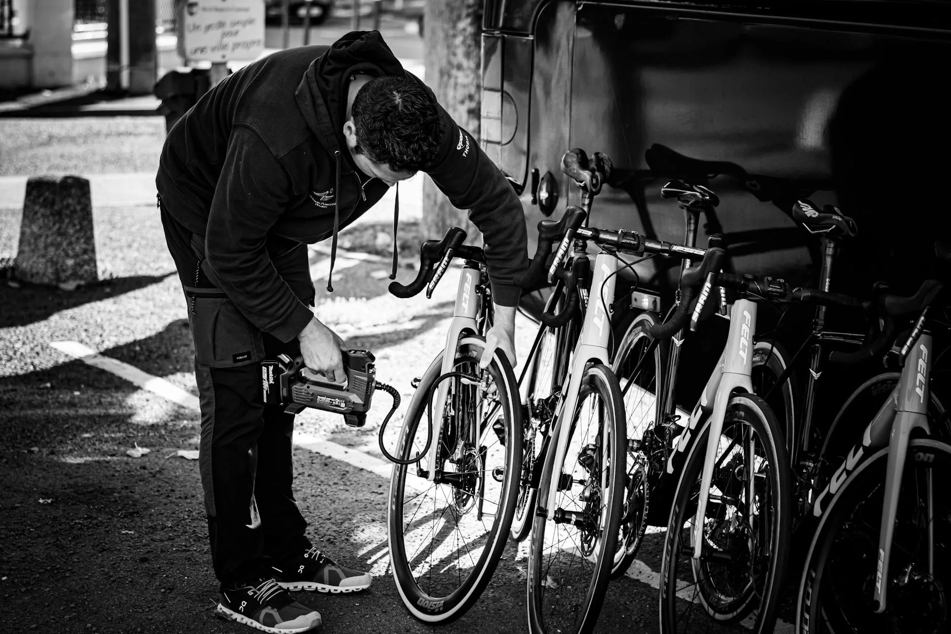 Checking tyre pressure on a bicycle with a hand pump and gauge
