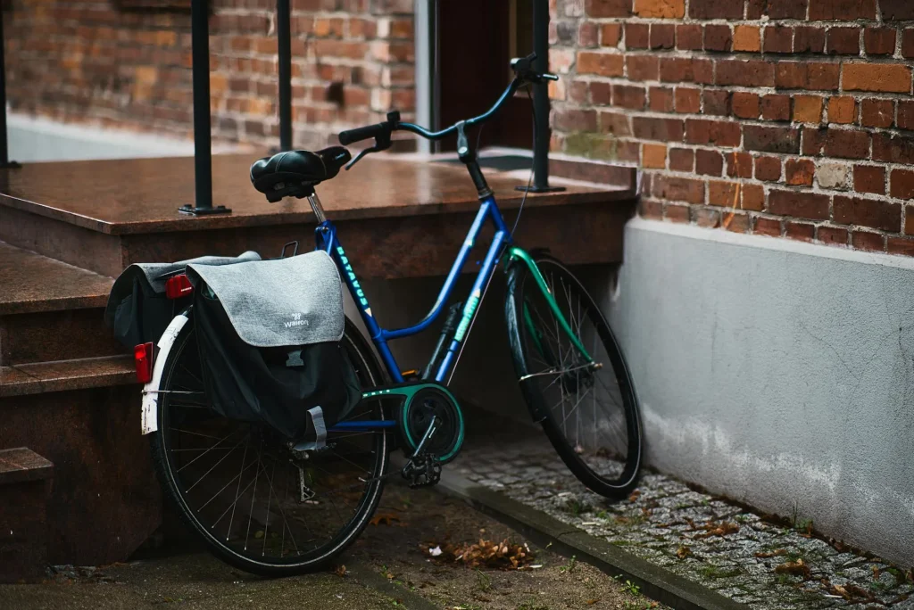 Cyclist with pannier bag on bicycle commuting through city