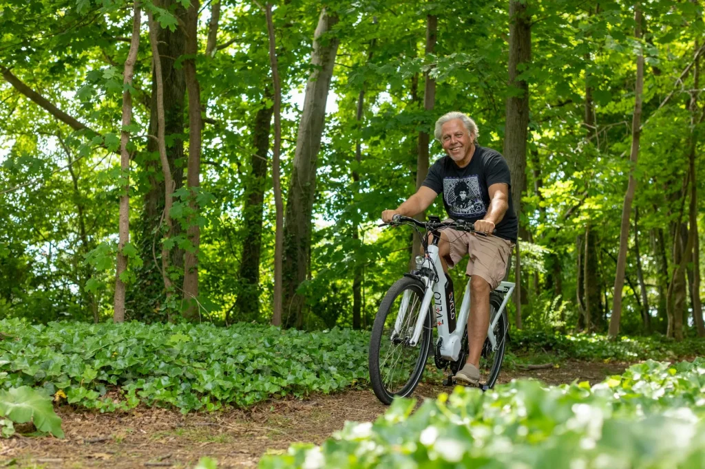 Person trying an e-bike for size in a bike shop