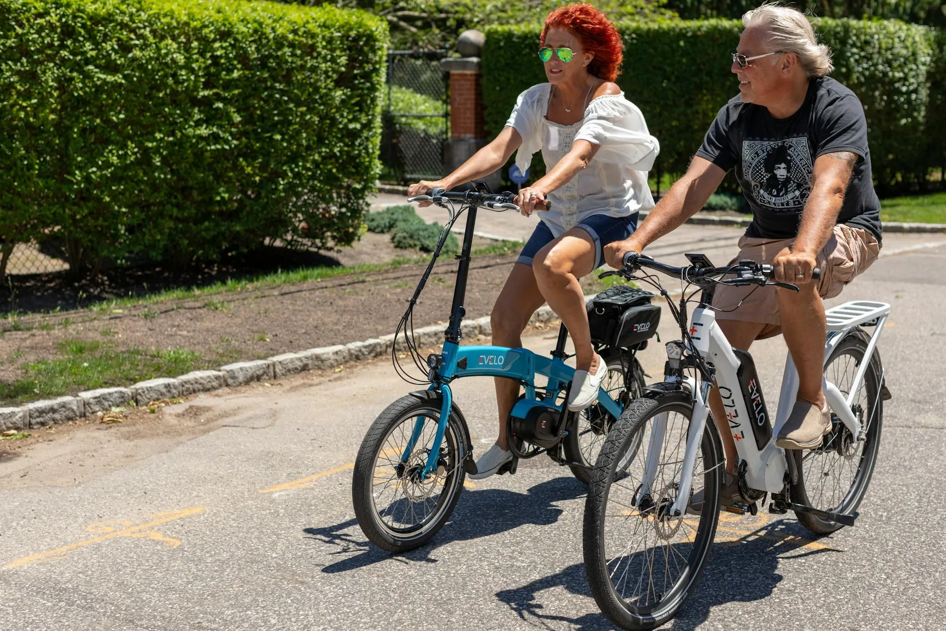E-bike commuters cycling upright through a suburban road