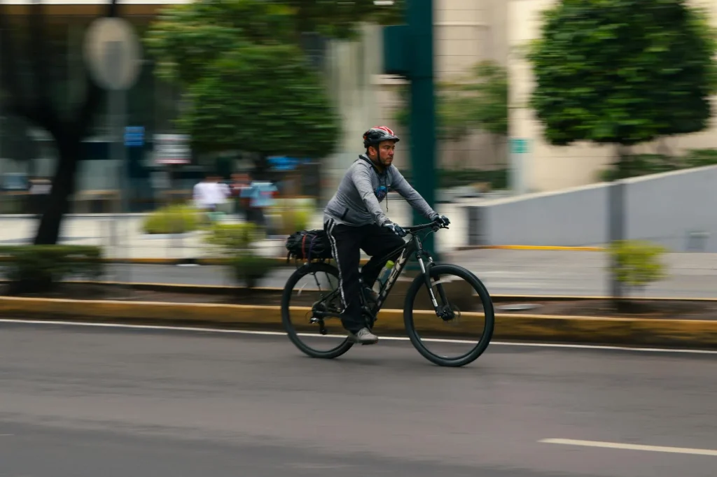 Cyclist riding an electric bike on an urban road for commuting