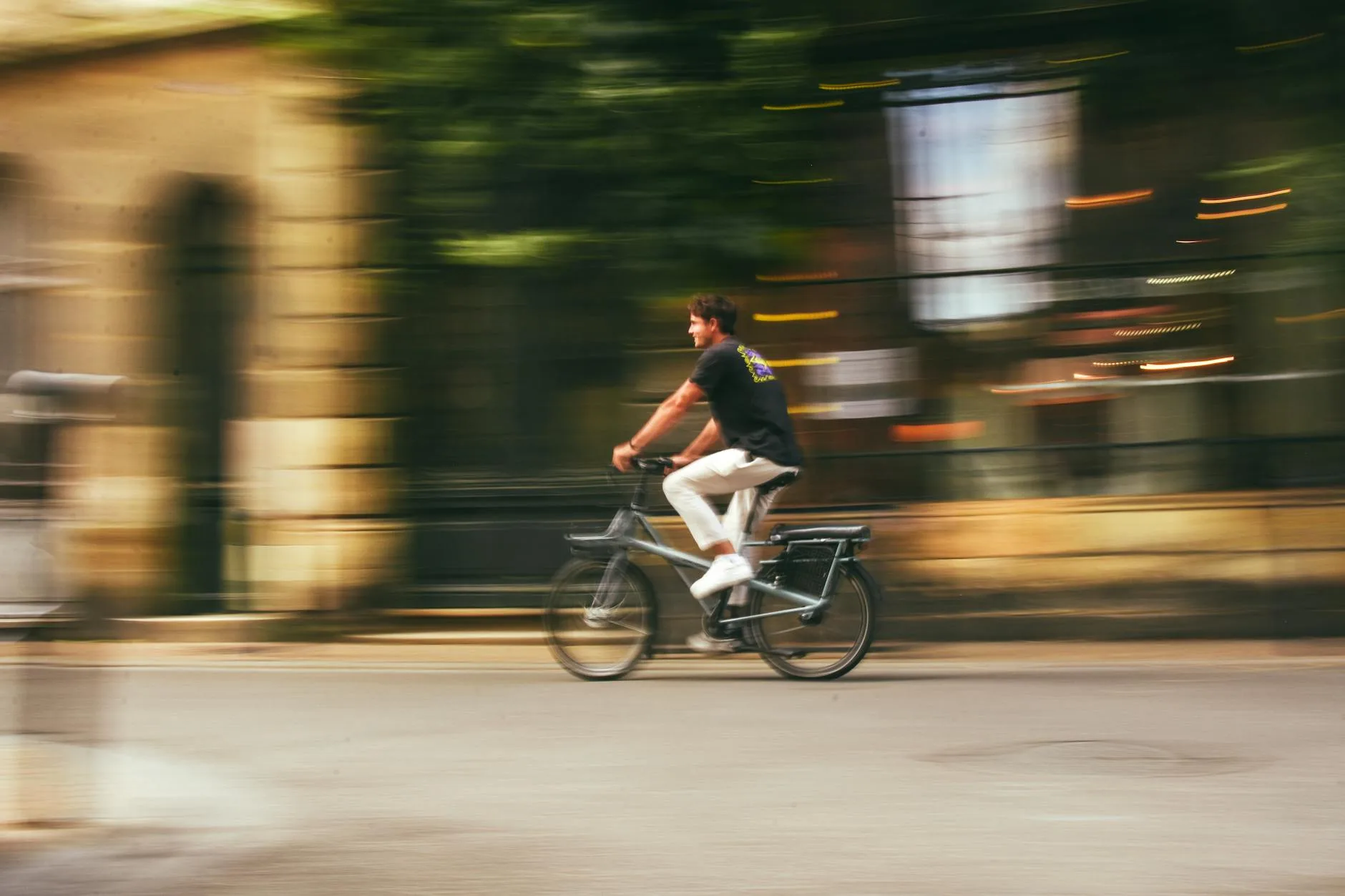 Person riding an electric bike through a city on a commute