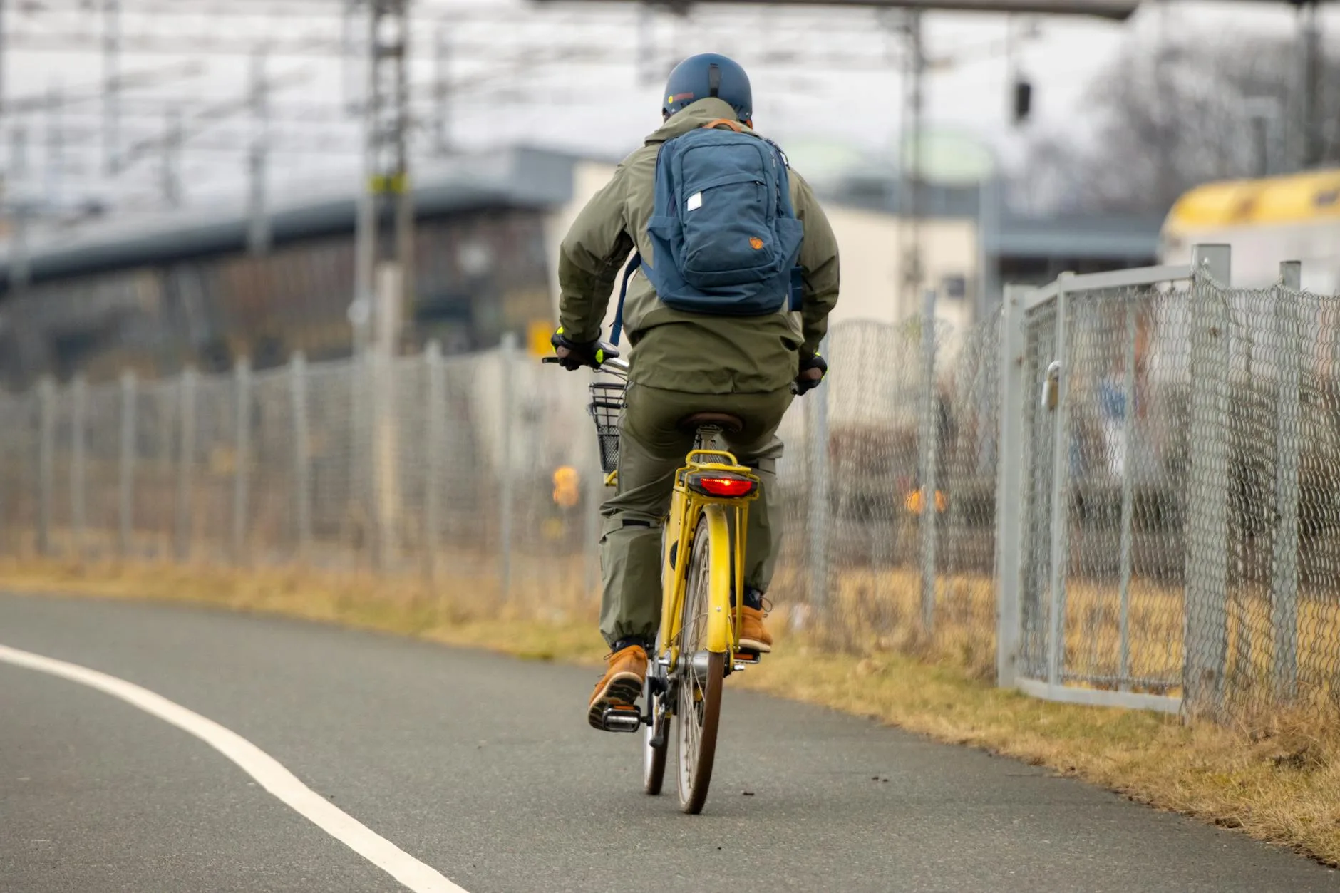 Person riding an electric bike along an urban cycle path