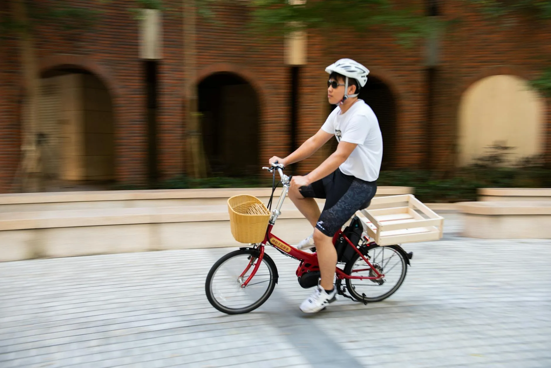 Person riding a small-wheeled folding bike through urban streets