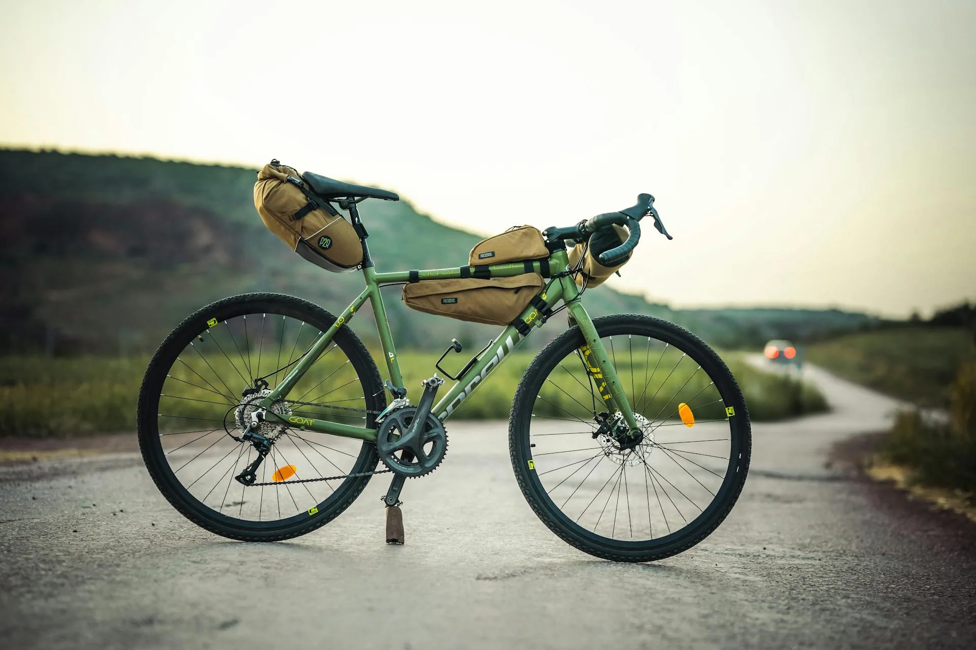 Fully equipped touring bicycle with panniers on a scenic rural road