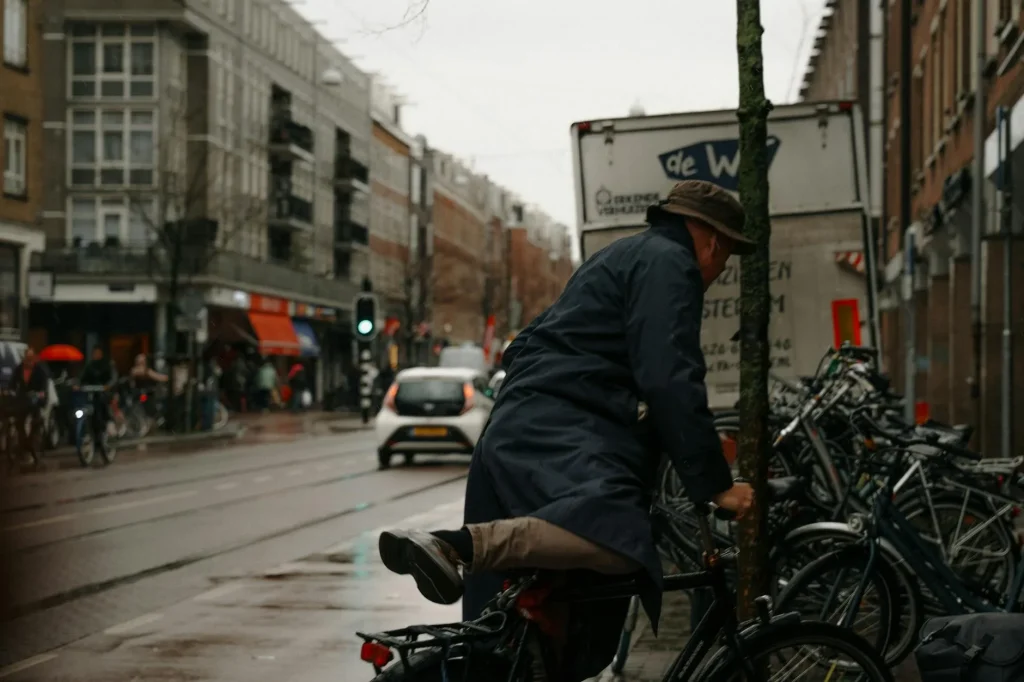 Cyclist riding a bicycle on a wet road in rainy UK weather