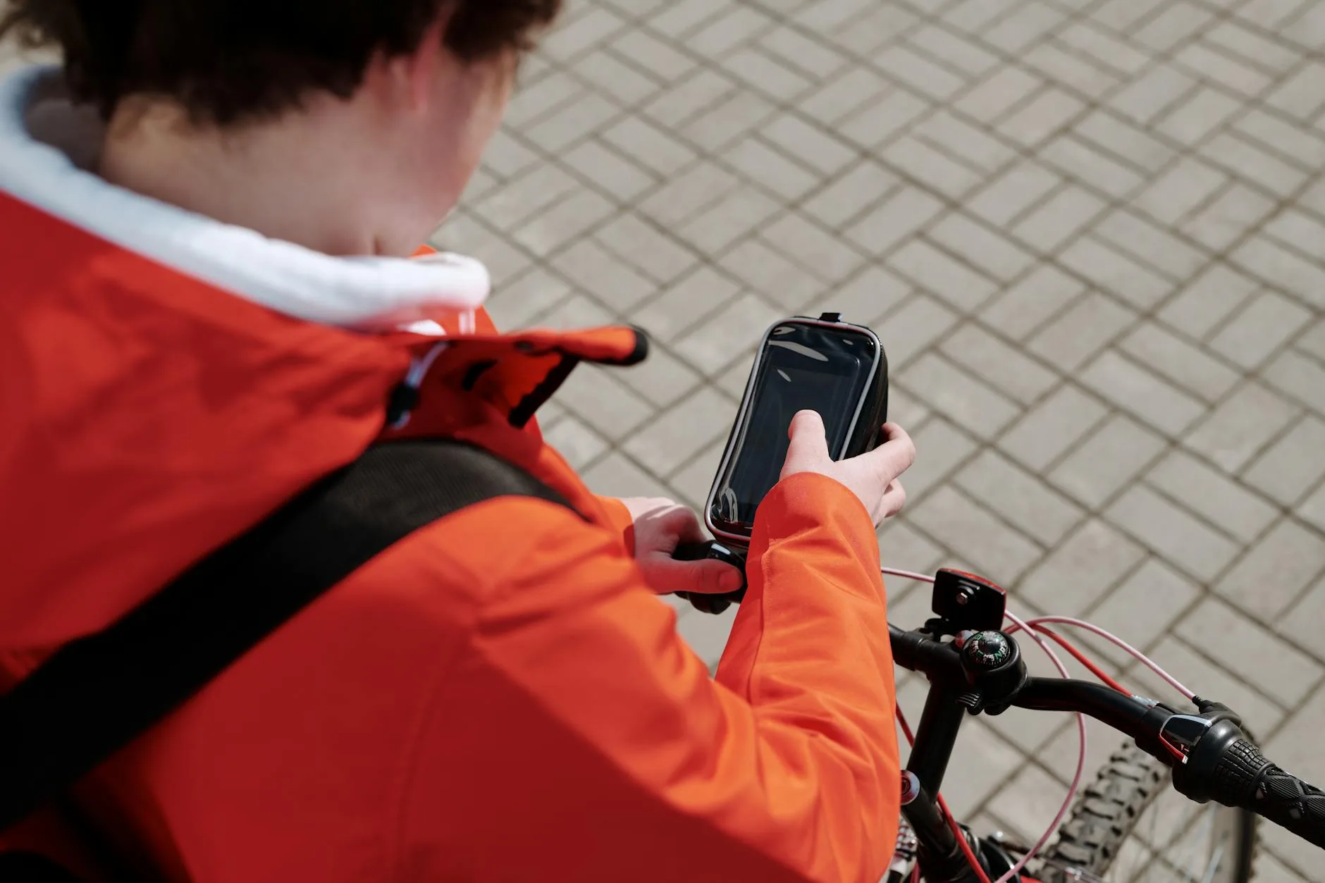 E-bike rider checking a route on a handlebar phone mount