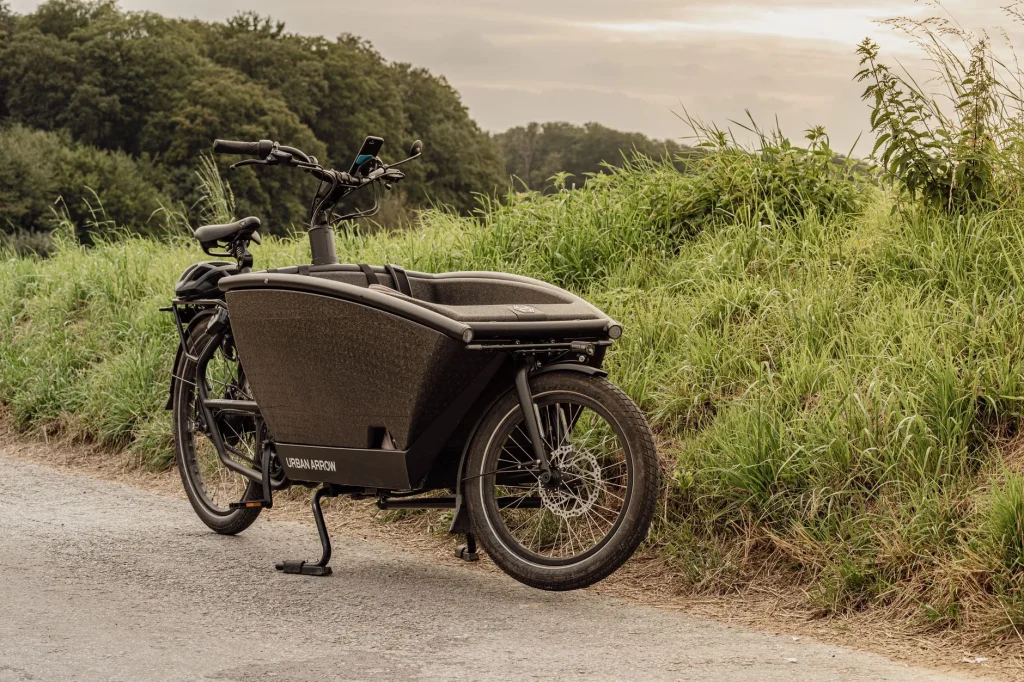 Cargo e-bike fitted with a child seat on an urban path