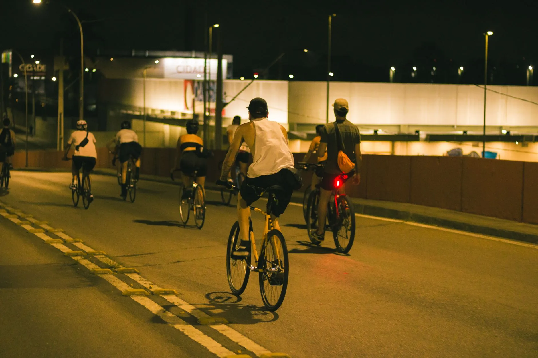 Cyclists using rear bike lights during a night group ride