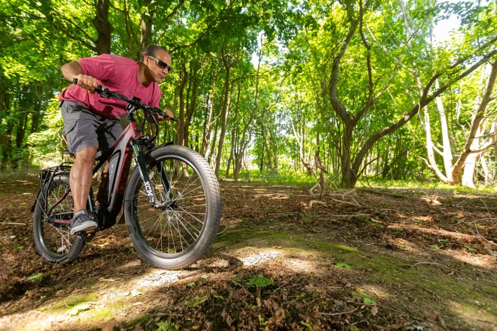 Off-road e-bike climbing a steep trail where motors can overheat